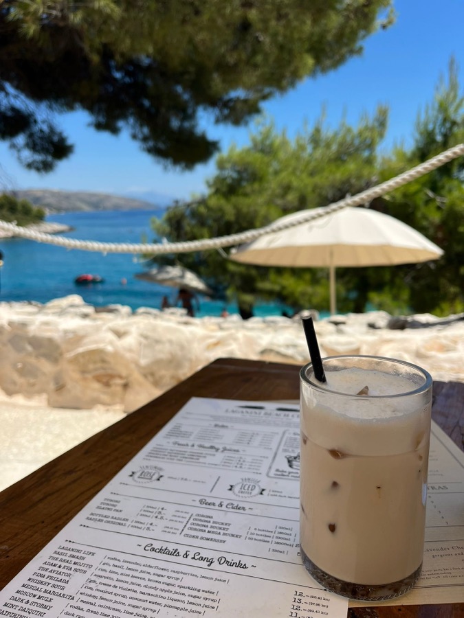 Iced coffee at a Croatian beach bar: limestone, turquoise Adriatic, the future CotR context
