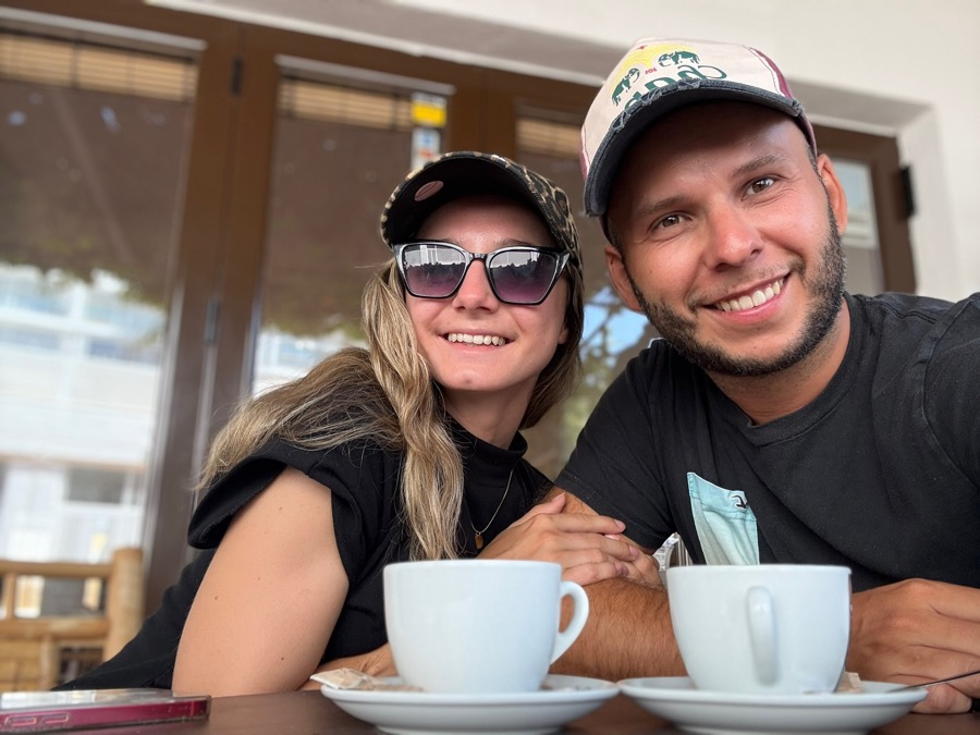 Markus and Vanessa at a cafe table, two coffees in front, field research for Cafe on the Roast
